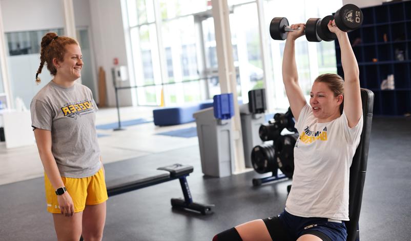 woman lifting weights above head